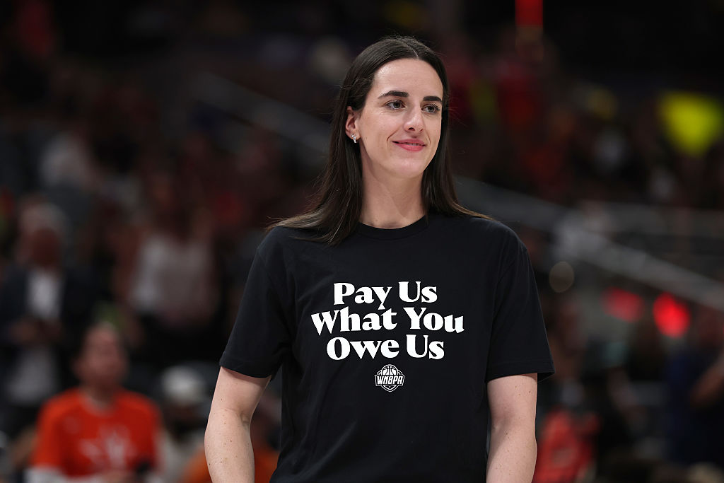 INDIANAPOLIS, INDIANA - JULY 19: Caitlin Clark #22 of the Indiana Fever wears a shirt saying "Pay us what you owe us" prior to the 2025 AT&T WNBA All-Star Game at Gainbridge Fieldhouse on July 19, 2025 in Indianapolis, Indiana. 